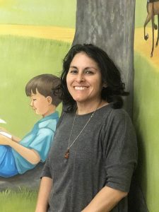 Image of Kathia in front of mural