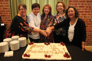 Pat Mora and company cutting a cake celebrating Dia's 15th anniversary