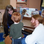 child examining a guitar