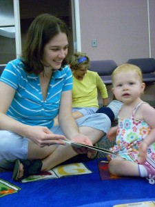 adult reading a book to a toddler