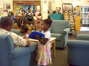 young girl exploring the library's toys