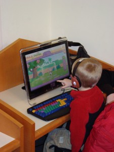 young boy playing Nick Jr. games on a computer