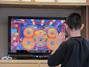 child engaging in video gaming on a large tv