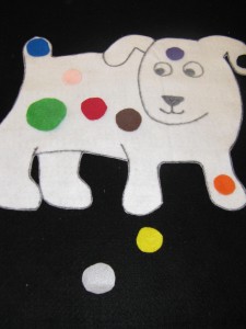 felt dog covered in colorful dots