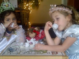 Two library patrons enjoy a cup of tea with Bobette.