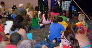 group of children listening to a presentation