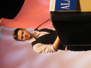 Chris Colfer at a podium
