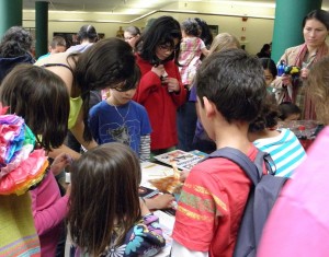 children working on origami at a table
