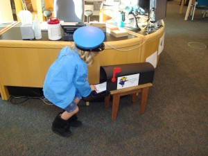 child placing a letter into a mailbox