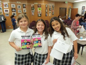 girls posing with Mad Libs book