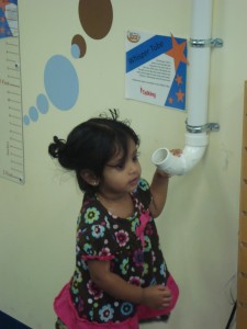 child trying the whisper tube