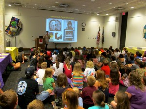 children sitting on the floor listening to instructions