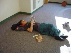 child laying on the floor reading