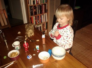 young child looking at mini books