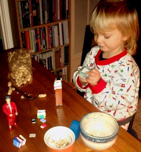 young child looking at mini books