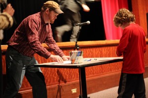 Aaron Zenz, author playing a drawing game with a young audience member