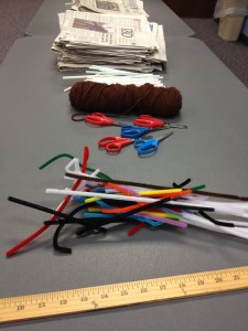 materials (scissors, pipe cleaners, newspaper, and yarn) prepped for engineering activity