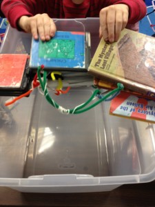 stack of books over a clear bin