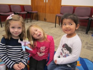 three young girls sitting on the floor