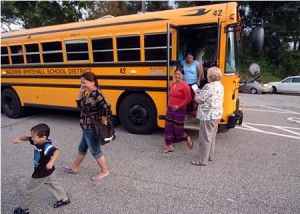 people stepping off a bus