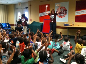 children sitting on the floor with their hands in the air