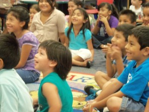 children sitting on the floor laughing
