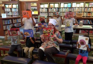 kids holding up their paper crafts
