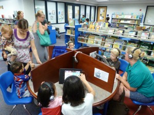 adults and children engaged with tablets