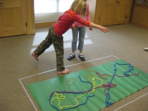 children creating art with yarn