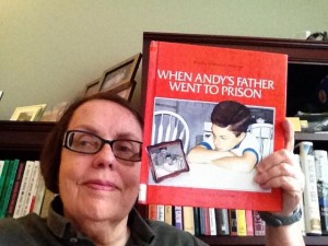 Kate Todd holding the book When Andy's Father Went to Prison