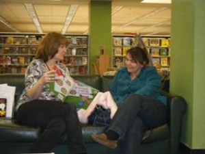 two adults reading If You Give A Mouse a Cookie