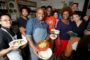 group of people holding plates with food
