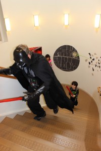 child chasing Darth Vader