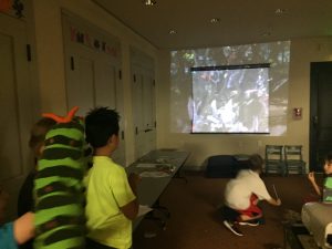 Kids watching movie screen