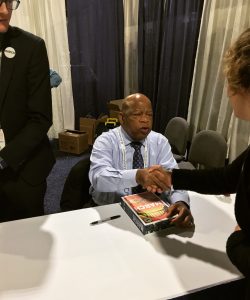 Photo of Rep. John Lewis signing his book