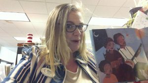 Photo of woman reading a picture book