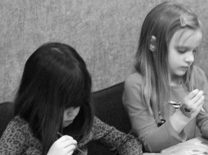 Two young girls concentrating on their work