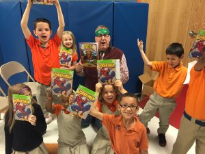 Excited kids showing their Spiderman commic books