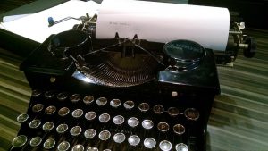close up of a type writer and paper