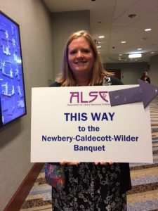 local arrangements committees holding signs for the banquet