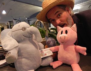 Mo Willems with Elephant & Piggie plush toys and a children's book card