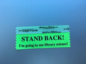 Badge ribbon reading "STAND BACK! I'm going to use library science