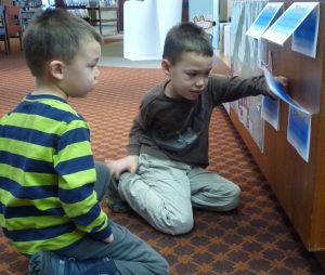 Two children looking at a Lift-the-Flap display