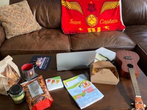 Managing from a distance often utilizes a living room office, complete with snacks and a ukuele on the coffee table