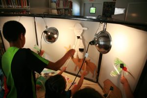children performing shadow puppet show