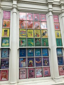 Picture of book display, rainbow colored book covers for pride