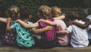 Children with their arms around each other visually representing the post title ""Real Connection in a Virtual World"