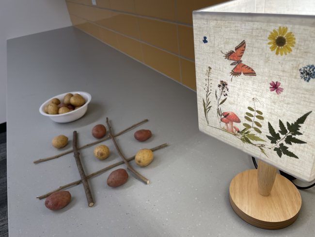 A game of Tic-Tac-Potatoe set up next to a lamp in one of the Program Rooms for the library's Hobbit Day Party