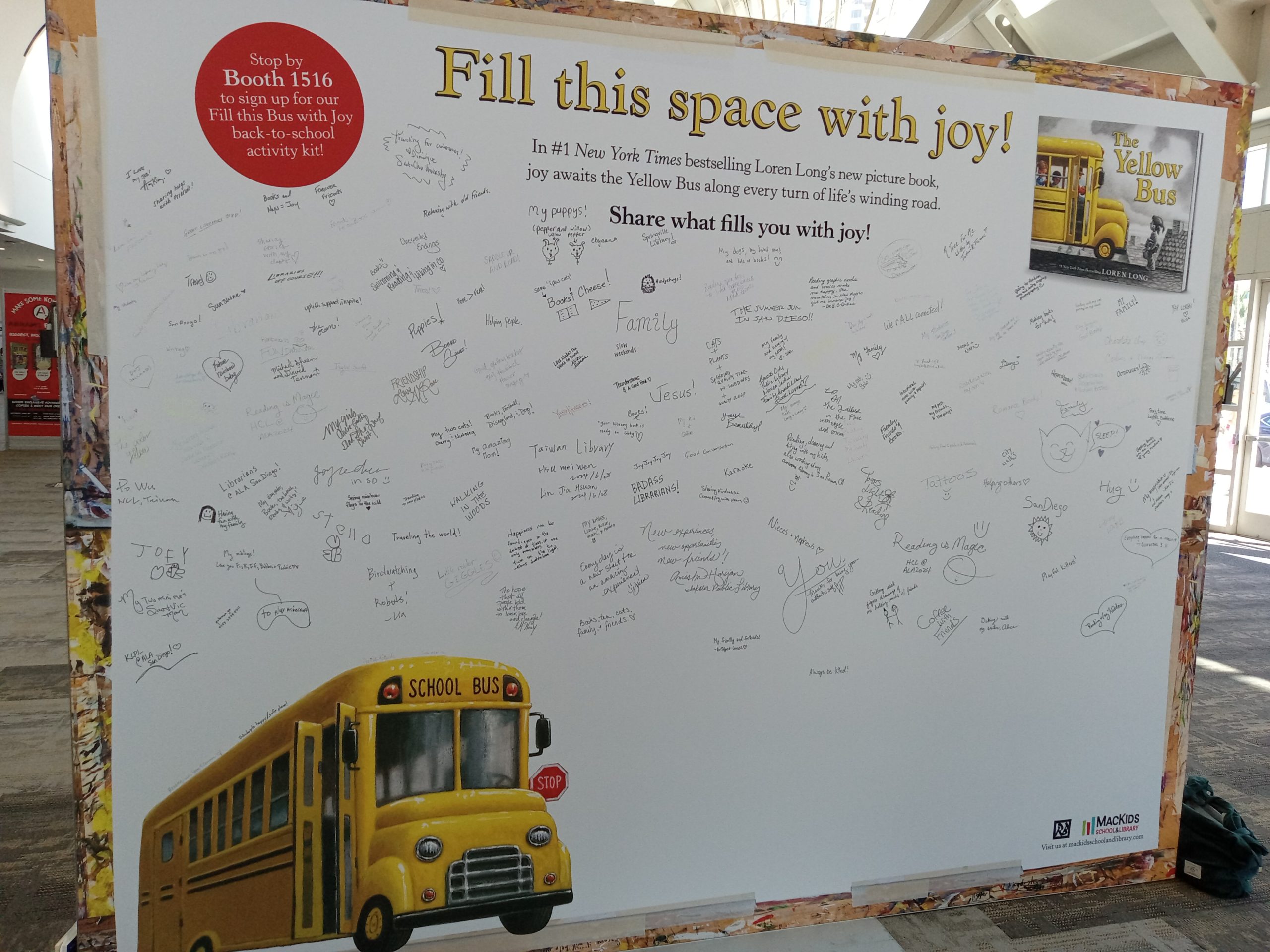 A large white poster with a yellow bus in the bottom left corner reads "Fill this space with joy!" Underneath the title, handwritten notes reflect individual joy.