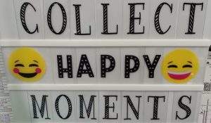 A personal light box displays the message "Collect Happy Moments" with two smiley-face emojis.